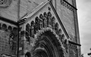 Vintage-style photograph capturing the intricate details of Ják Church's façade in Hungary.